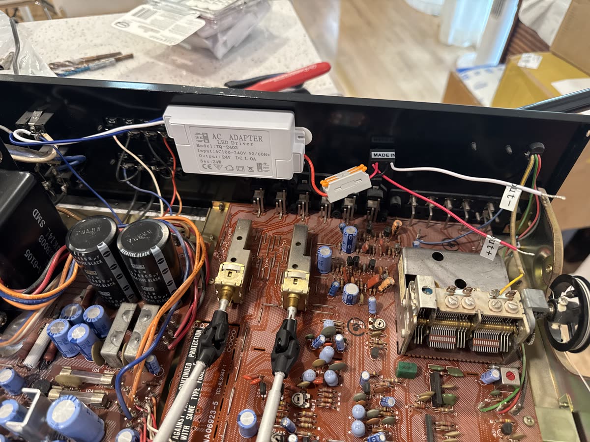 The AC adapter soldered into the switched outlet
