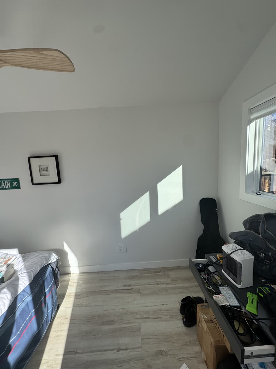 The bare wall before shelving